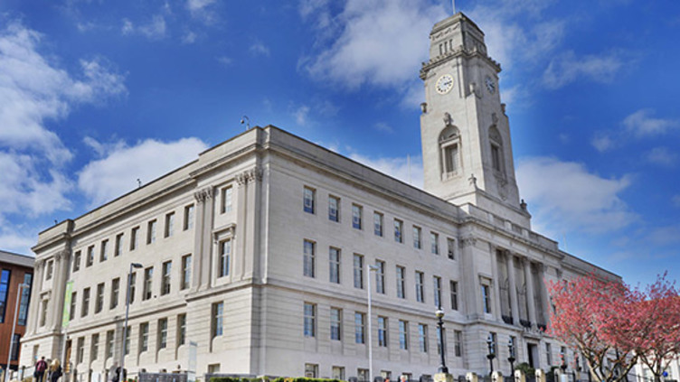 Barnsley Town Hall showing the front and side elevations, along with the clock tower and blue sky.