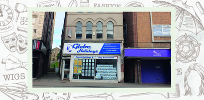 The shopfront for Globe Holidays with adverts in the window.