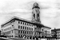 Exterior view of Barnsley Town Hall in 1935 with gardens and war memorial in foreground.