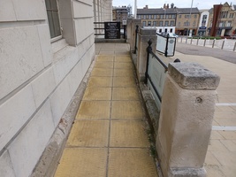 The accessible entrance slope to Experience Barnsley Museum with Church Street shops in the background.
