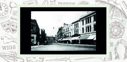 Postcard image showing shops with their awnings protecting goods in their windows. Shop signs for Tetley, Jackson and Harrals Ring Shop are visible.