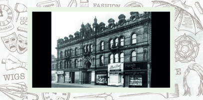 Entrance to Civic Hall, and shopfronts for Singer, Albert Hirst and Haigh Brothers.