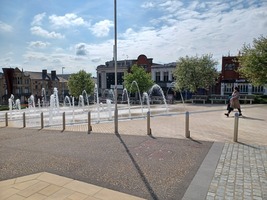 Fountains in flow in Barnsley Pals Centenary Square looking towards Market Hill