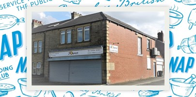 Shop with white sign and roller shutter down over windows.