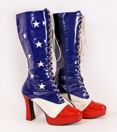 Knee-high platform boots with red soles and toes, white fronts, and blue shafts featuring white stars. The boots have side zippers and front laces.