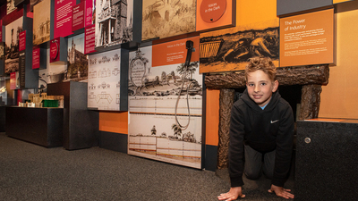 A child posing for a photograph outside the fake coal mine in Experience Barnsley