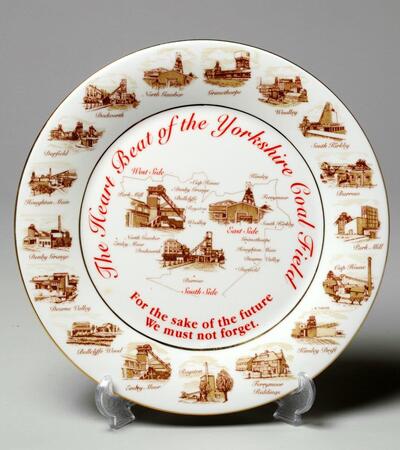 A mining commemorative plate with illustrations of mining scenes, the text reads, "The Heart Beat of the Yorkshire Coal Field. For the sake of the future, we must not forget"