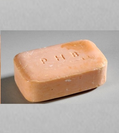 a pink bar of soap with the letters PHB carved in the top