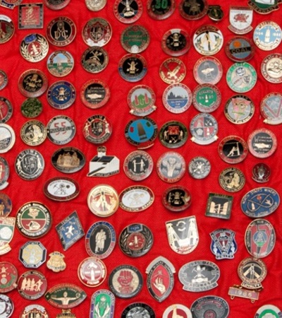 a collection of enamel badges on a background of red material